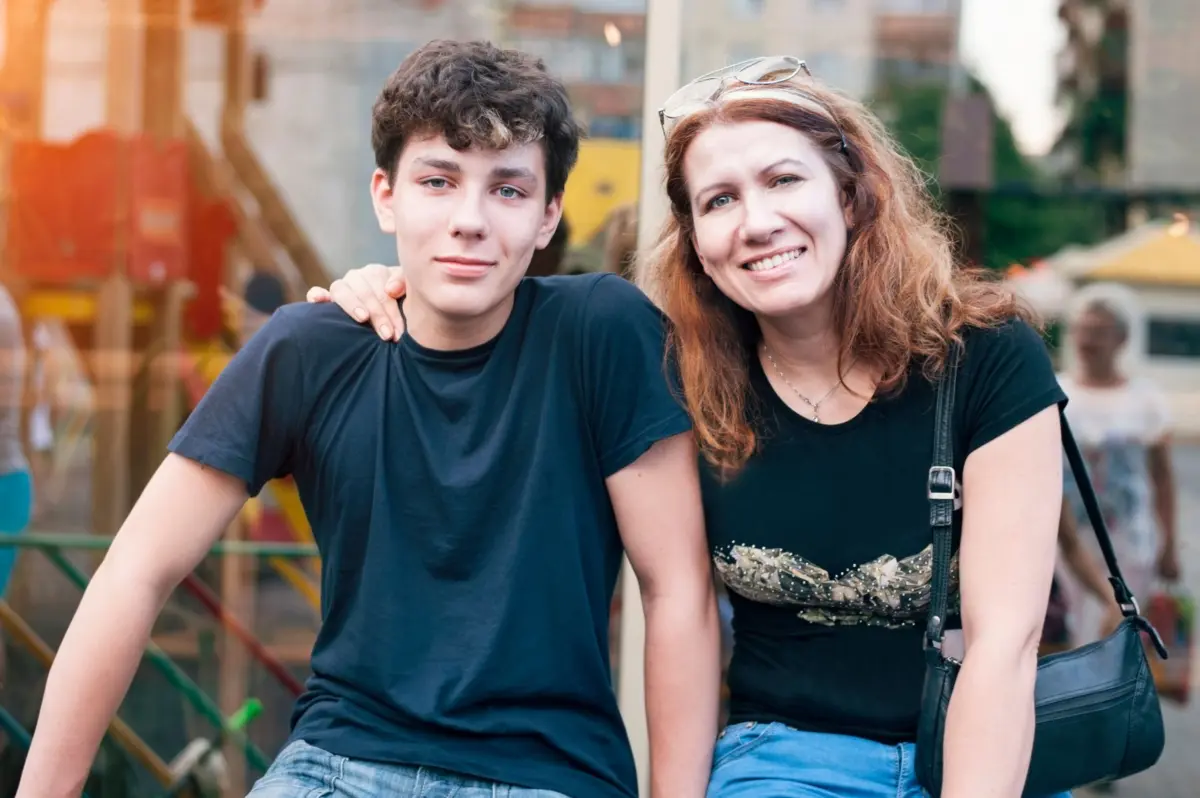 mom with arm around teenage son