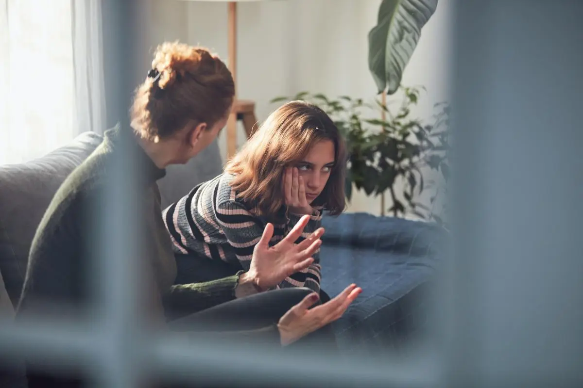 therapist talks to teen girl in impulse control treatment