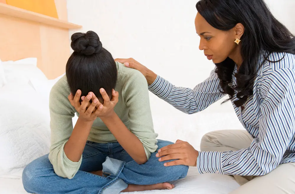 therapist consoles teen girl in thought disorder therapy
