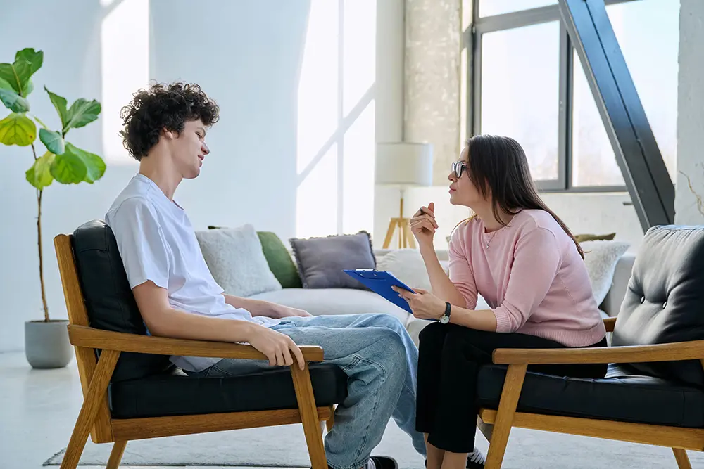 Teen speaking with a mental health counselor for emotional support.