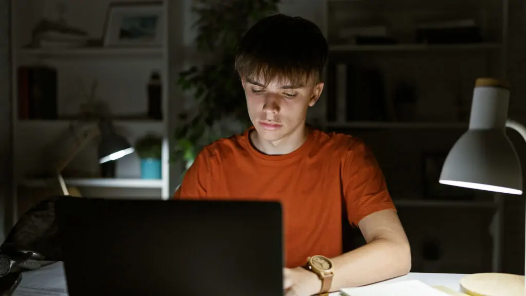 Teen studying late at night under academic pressure