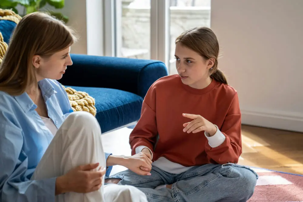 parent talking to teen about mental health in a supportive and open conversation