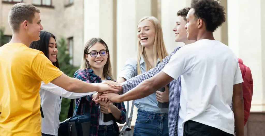 Teen alumni mental health program participants connecting in a supportive outdoor environment in Massachusetts