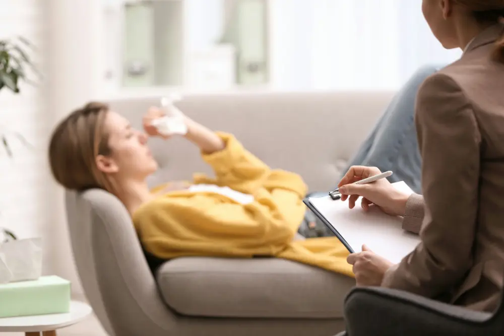 Adolescent discussing emotional challenges with a therapist during treatment for borderline personality disorder and addiction.