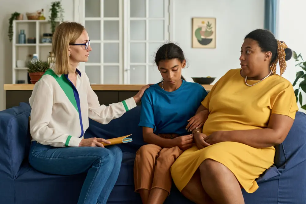 Teen participating in social anxiety disorder treatment with a therapist at an adolescent mental health center