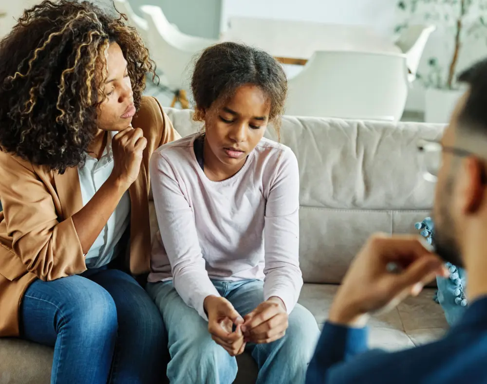 Therapist meeting with a teen and parent to create an individualized OCD treatment plan