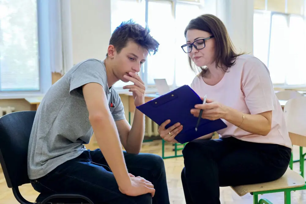 Adolescent working with a therapist to build healthy coping skills during trauma-informed therapy