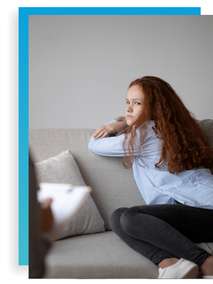 teen with bipolar disorder in therapy turned away from therapist on couch