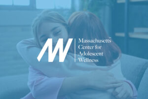 MCAW logo over ghosted image of two women embracing