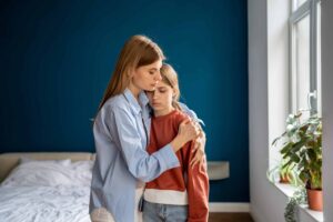 mother hugging child with mental health issues