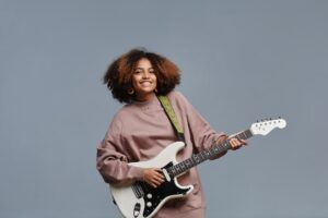 teen girl playing guitar