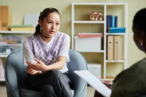 a teen asking a question in an intensive outpatient program for adolescent mental health