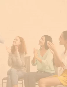 three teen girls clapping their hands at someone off-camera