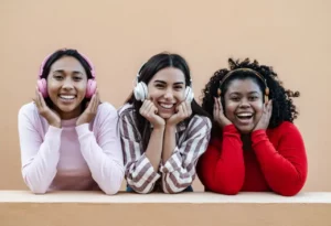 three teen girls wearing headphones in substance abuse treatment