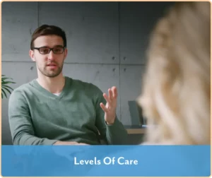 man with glasses talking to off-camera therapist
