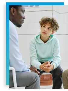 a teen looks at a therapist in an intensive outpatient program for adolescent mental health