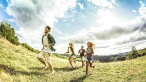 fisheye image of a group of teens running in a field