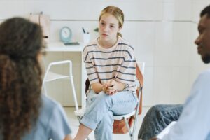 A teen girl listens in cognitive-behavioral therapy for adolescents