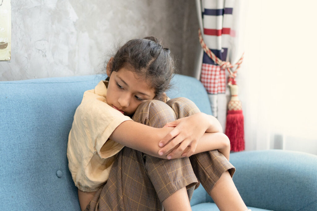 a teen girl showing signs of trauma in adolescence