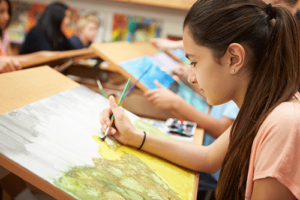 a group of teens draw during an art therapy program 