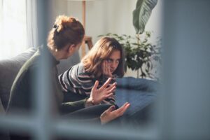 Parent talks to teen on couch about how to control impulsive behavior