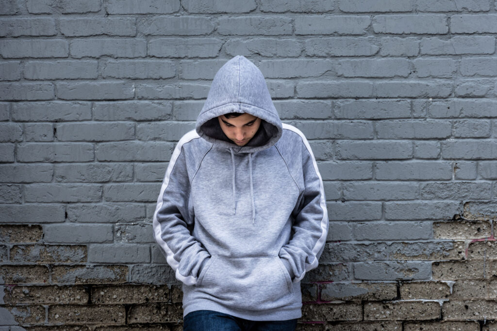 Teen leaning against the wall showing school refusal interventions