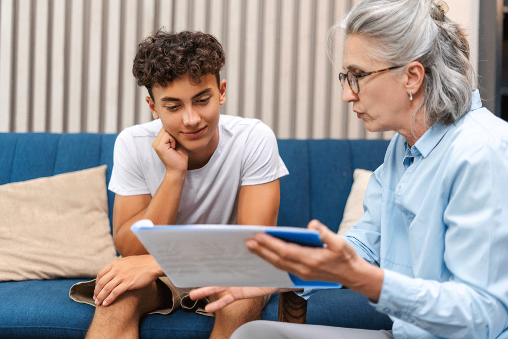 teenage boy talks with therapist about mental health screenings