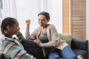 Woman talks to her parents about mental health concerns on couch