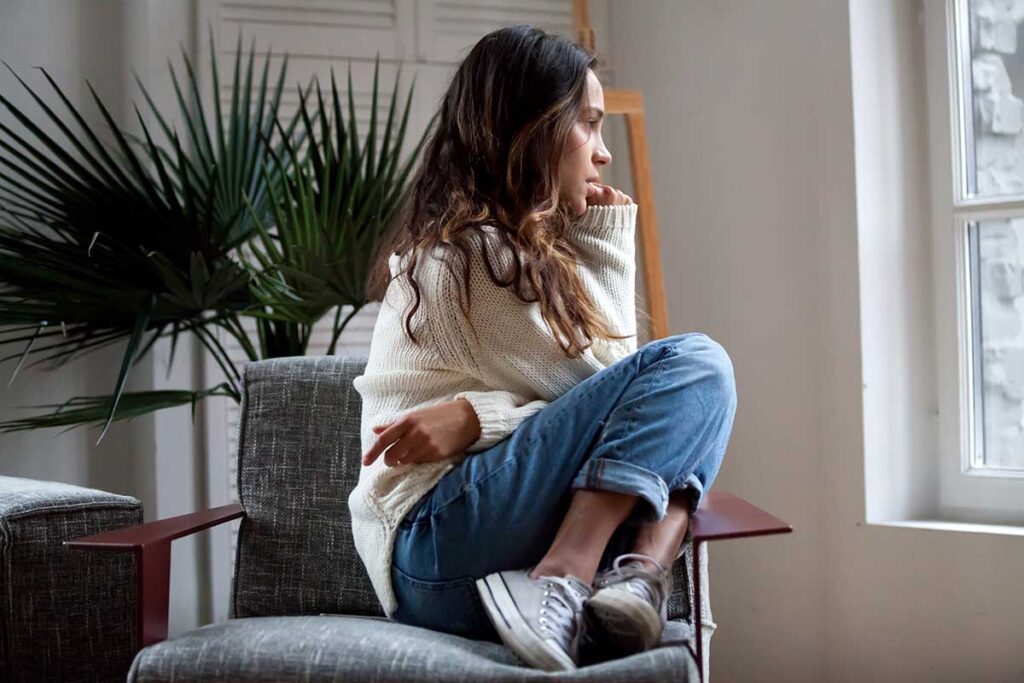 Woman sits in chair as she tries to fight intrusive thoughts
