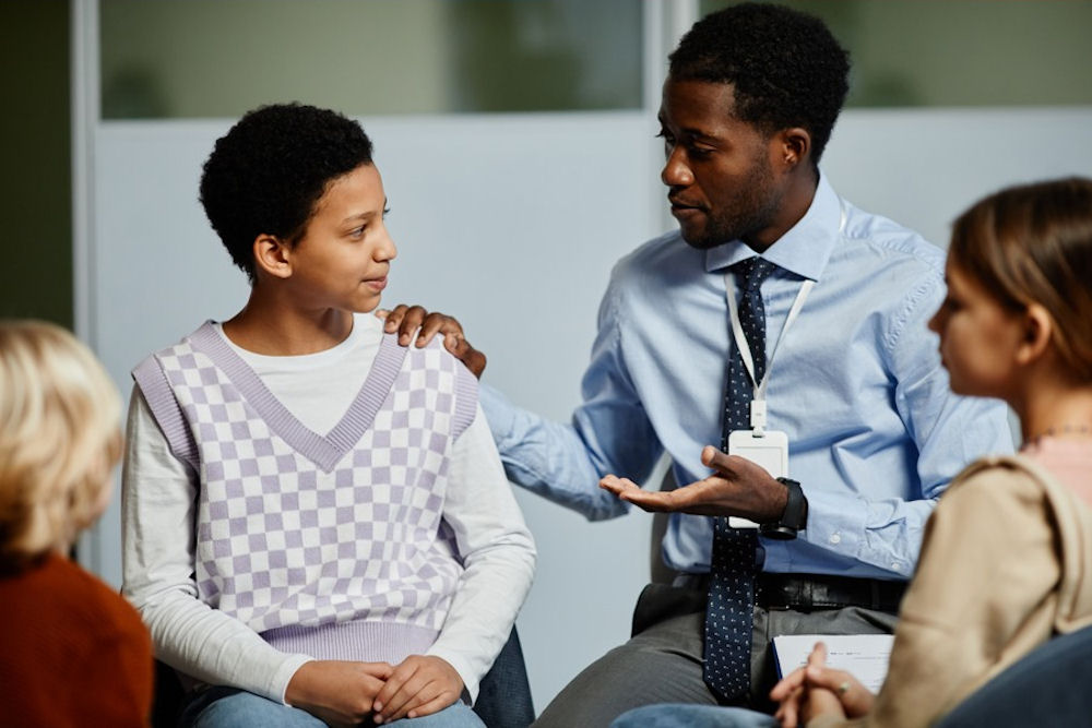 A teen girl, with her family and therapist, asks, 'What is parentification?