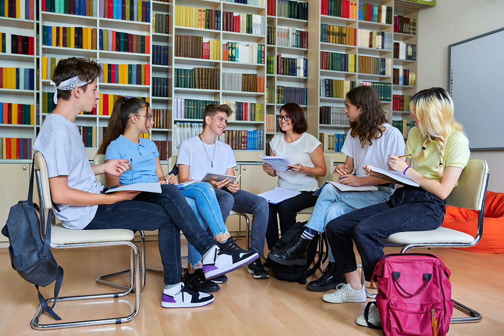Teens working together in a school setting, focusing on early intervention for child and adolescent mental health