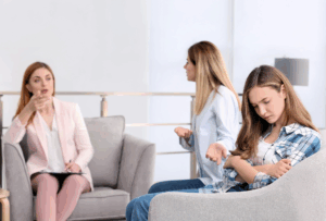 Teen and parent speaking with therapist at the Massachusetts Center for Adolescent Wellness about OCD and addiction treatment.