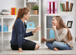 Mother supporting her teenage child during a heartfelt conversation about mental health.