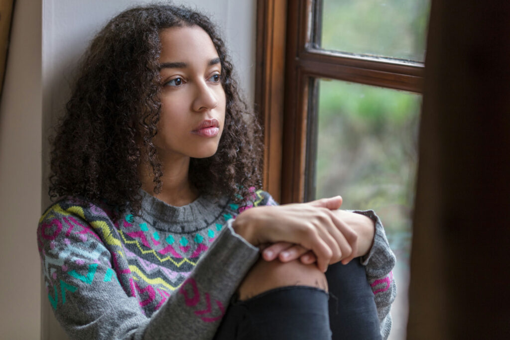 Teen in Massachusetts reflecting on recovery, symbolizing hope in dual diagnosis treatment for anxiety and addiction.