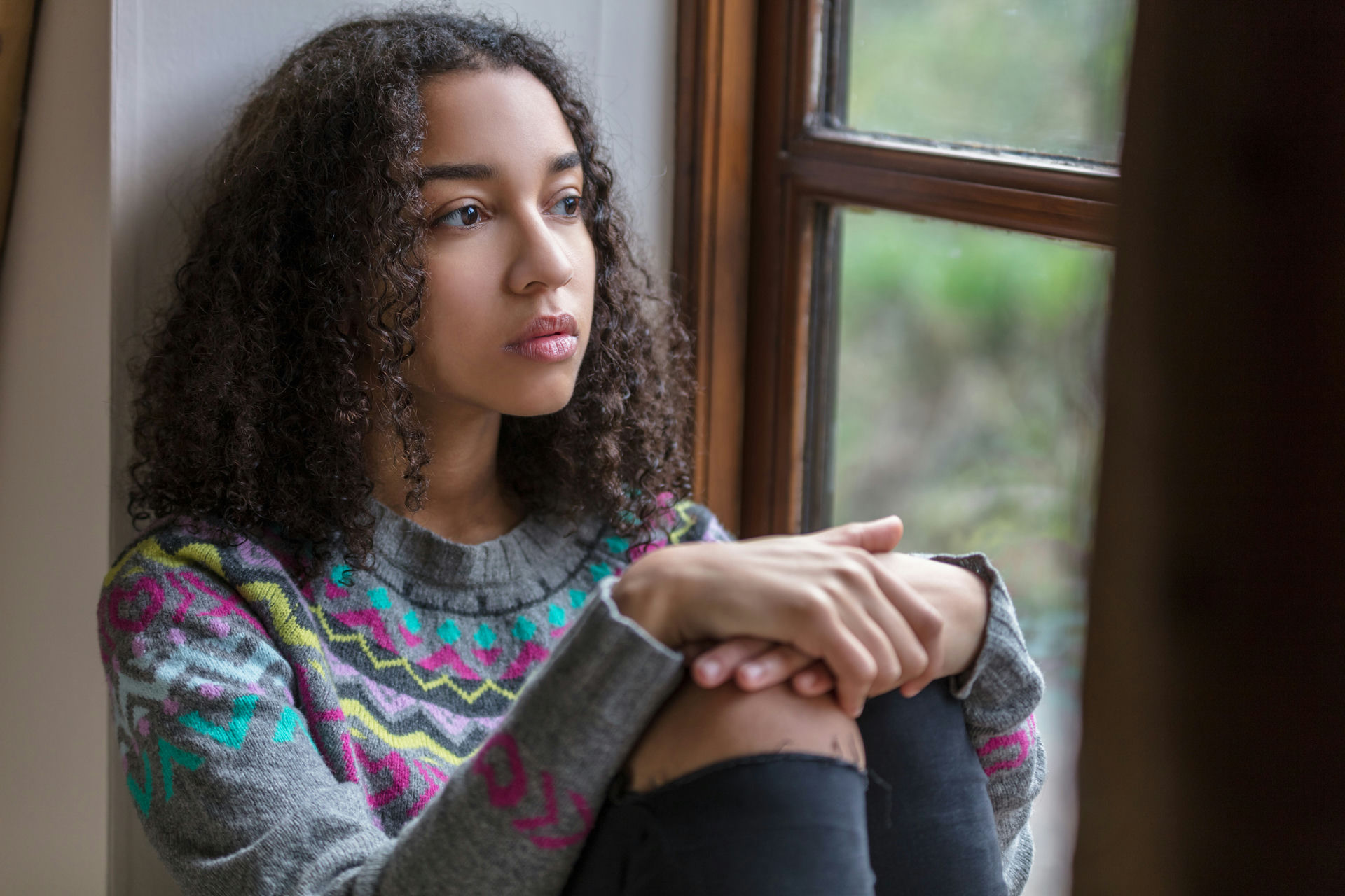 Teen in Massachusetts reflecting on recovery, symbolizing hope in dual diagnosis treatment for anxiety and addiction.