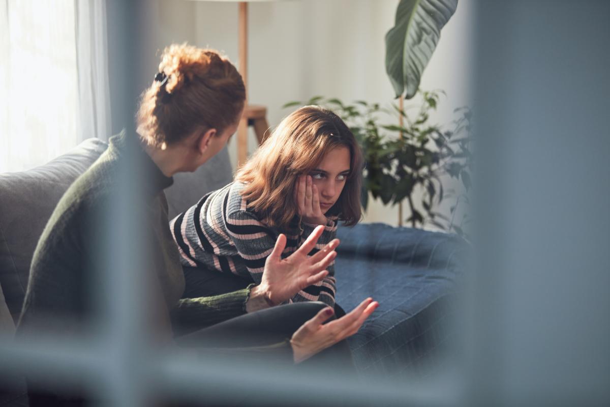 therapist talks to teen girl in impulse control treatment