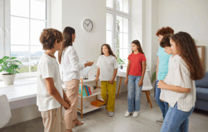 Group of teens participating in acceptance and commitment therapy with a counselor in a supportive setting.