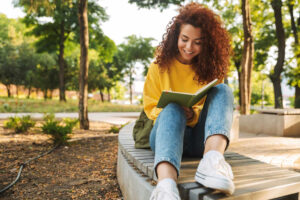Teen sitting outdoors reflecting on the transition to life after rehab