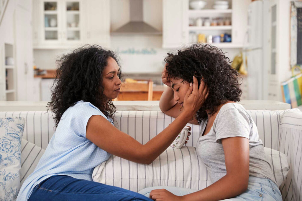 Parent talking with child about drugs in a calm and supportive home setting