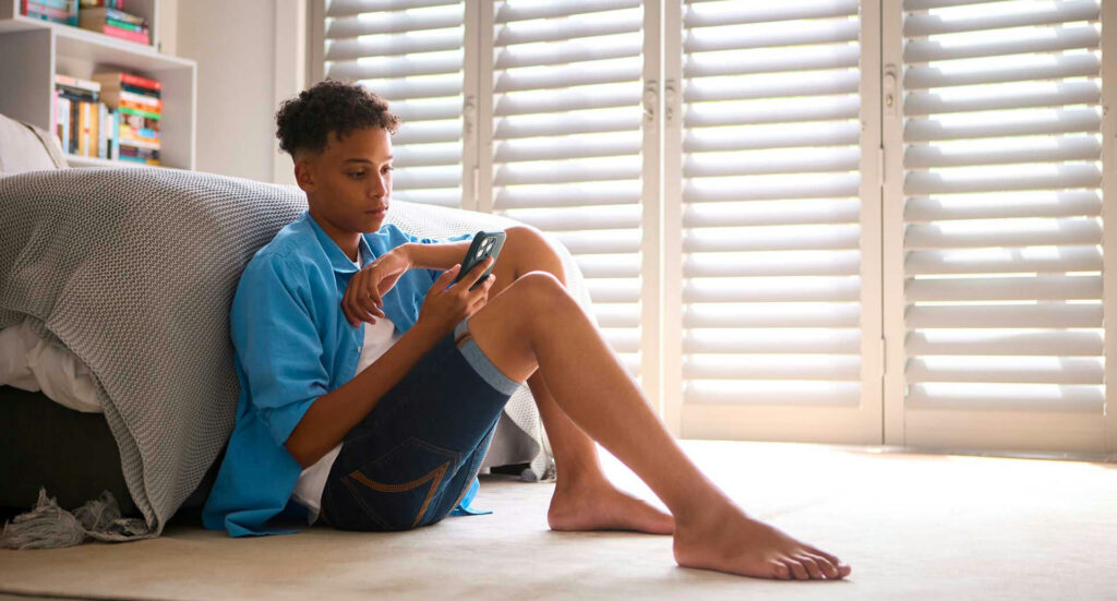 Teen forming an emotional connection with an AI chatbot, highlighting risks of AI dependency