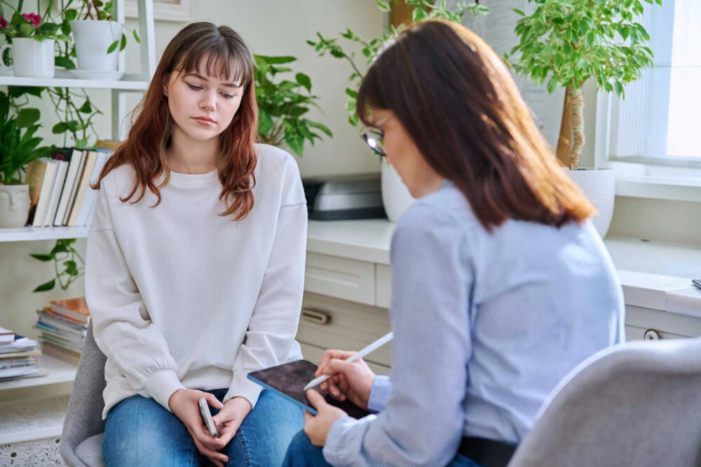 Teen participating in adolescent depression treatment with therapist at a teen depression treatment center in Massachusetts