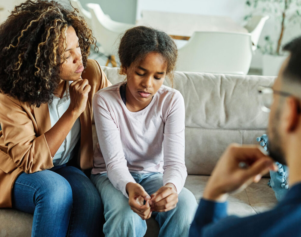 Therapist meeting with a teen and parent to create an individualized OCD treatment plan