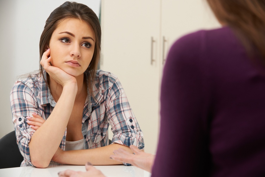 Aloof teenage girl in trauma treatment.
